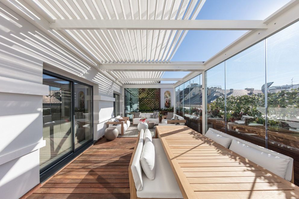 Adjustable and retractable slatted pergolas